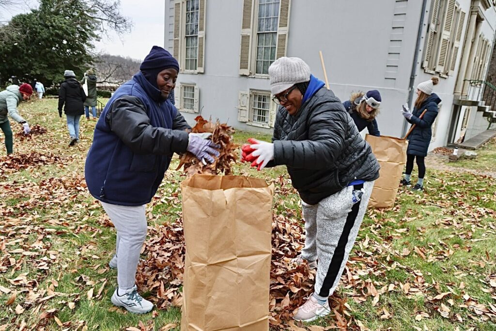 Nanette Daniels (right) and her aunt, Joanna Brown, bag leaves during a Martin Luther King Day of Service event at Sweetbriar Mansion in West Fairmount Park.