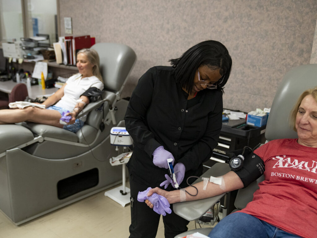 Shooting At Louisville, Kentucky Bank Leaves At Least Five Dead A medical professional helps a woman who is donating blood.
