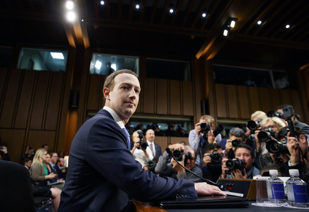 Facebook CEO Mark Zuckerberg arrives to testify before a joint hearing of the Commerce and Judiciary Committees on Capitol Hill in Washington, Tuesday, April 10, 2018, about the use of Facebook data to target American voters in the 2016 election. (AP Photo/Carolyn Kaster)