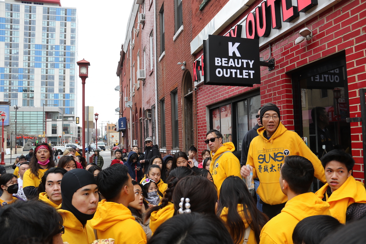 Philadelphia Suns leaders and members gathered ahead of the Lunar New Year Parade in Chinatown to make sure everything was in order before dancing through the streets. (Cory Sharber/WHYY)