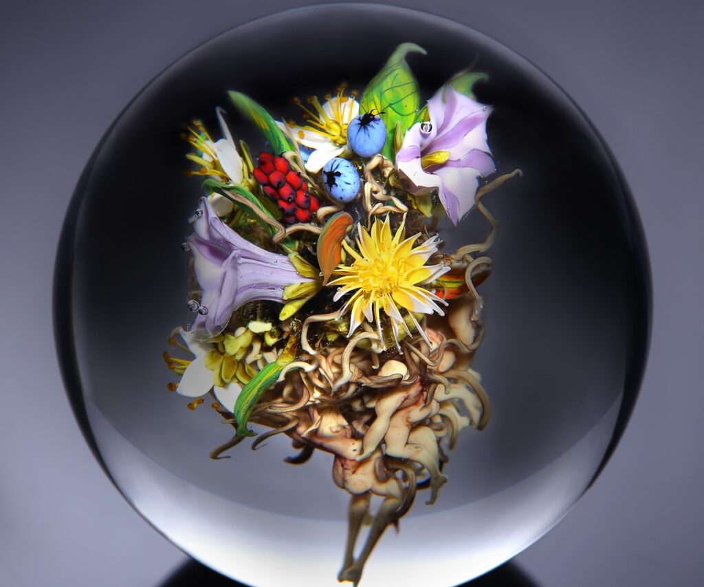 An artwork showing a bouquet in a glass orb