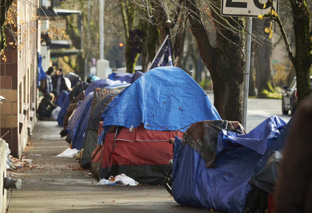 Tent City Portland Oregon Tents line the sidewalk on SW Clay St. in downtown Portland, Oregon in December 2020. (AP Photo/Craig Mitchelldyer, File)