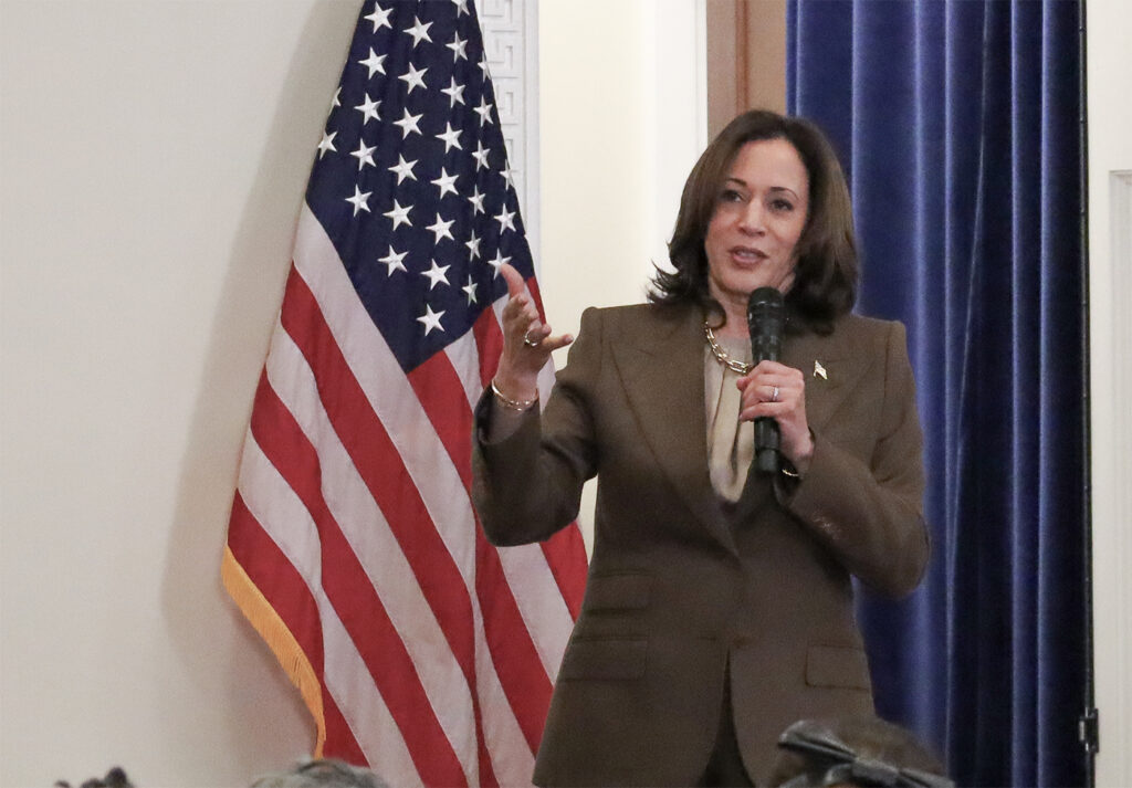 Kamala Harris speaking into a microphone