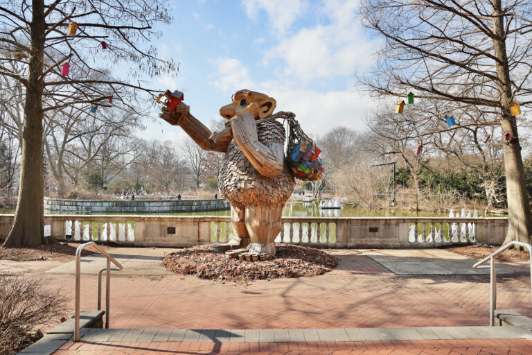 The troll Ibbi Pip is surrounded by colorful birdhouses at her location outside the Philadelphia Zoo's avian center.