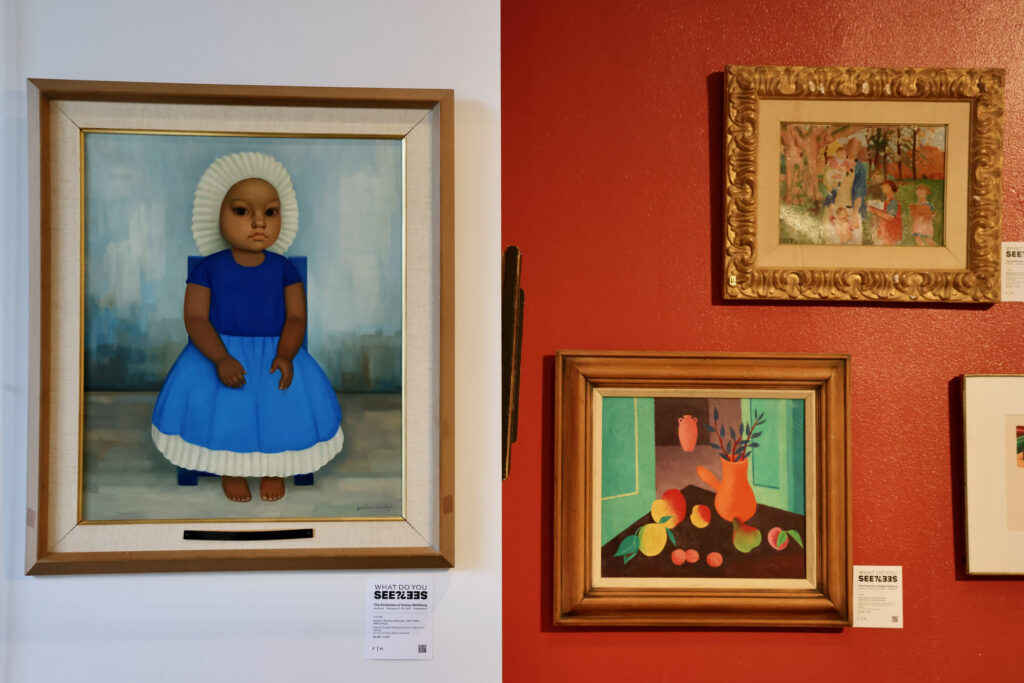 Paintings hung on the wall in the exhibition