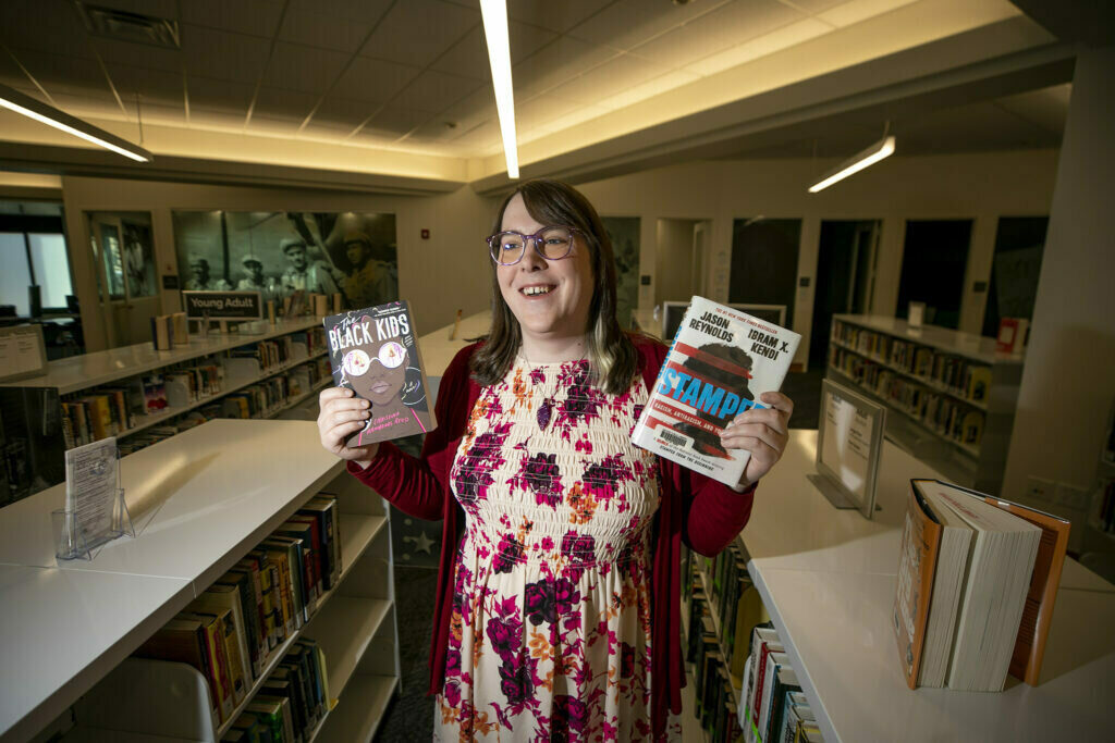 Blair-Caldwell African American Research Library teen librarian Juno Kling holds some of her favorite books.