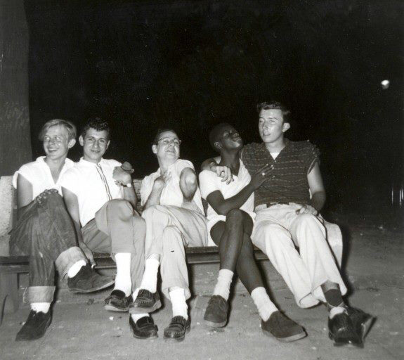 People posing on a park bench