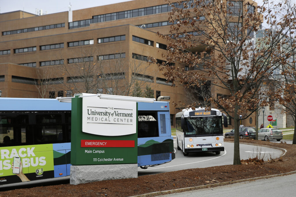 Buses travel through the main campus of the University of Vermont Medical Center, Friday Nov. 20, 2020, in Burlington, Vt.