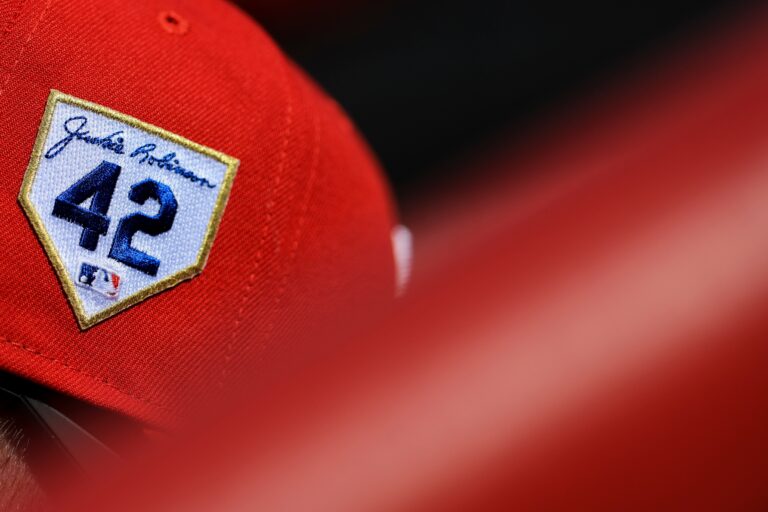 The Jackie Robinson patch is seen on a Philadelphia Phillies hat in the dugout during a baseball game against the Cincinnati Reds in Cincinnati, Saturday, April 15, 2023