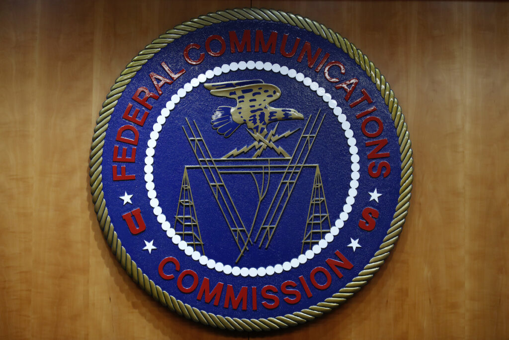 FCC Digital Divide Rule The seal of the Federal Communications Commission (FCC) is seen before an FCC meeting to vote on net neutrality, Dec. 14, 2017, in Washington. (AP Photo/Jacquelyn Martin, File)