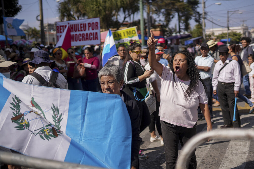 Supporters of Guatemalan President-elect Bernardo Arévalo protest a delay in the start of the legislative session