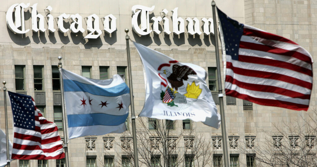 Newsroom Strikes-Tribune In this April 12, 2006, file photo, flags wave near the Chicago Tribune Tower in downtown Chicago. More than 200 reporters, photographers and other staffers with the Chicago Tribune and six other newsrooms around the nation began a 24-hour strike Thursday, Feb. 1, 2024 to protest years of “slow-walked” contract negotiations and to demand fair wages.