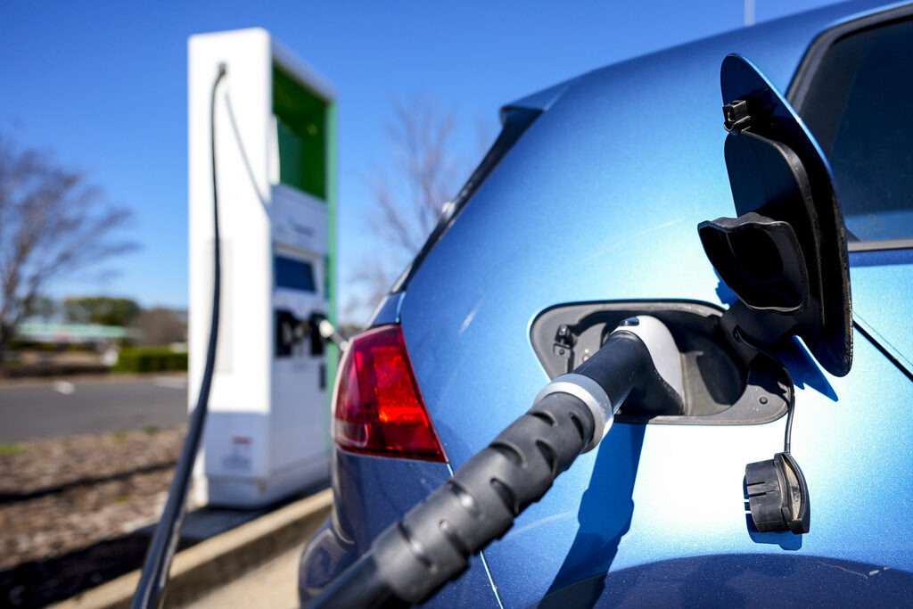 A close-up of a vehicle charging with an electric charger.