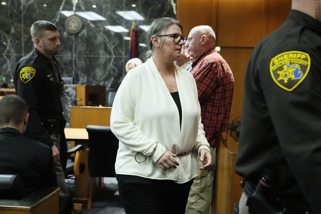 School Shooting Mother Charged Jennifer Crumbley is escorted away, Monday, Feb. 5, 2024 in Pontiac, Mich. The jury received instructions from a judge and begin deliberations in an unusual trial against a school shooter's mother. (AP Photo/Carlos Osorio, Pool)