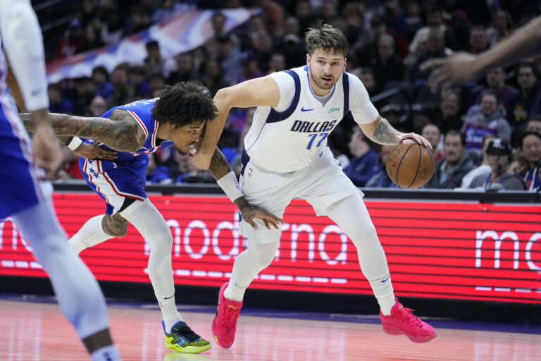 Dallas Mavericks' Luka Doncic (right) tries to get past Philadelphia 76ers' Kelly Oubre Jr. (left) during the first half of an NBA basketball game, Monday, Feb. 5, 2024, in Philadelphia.
