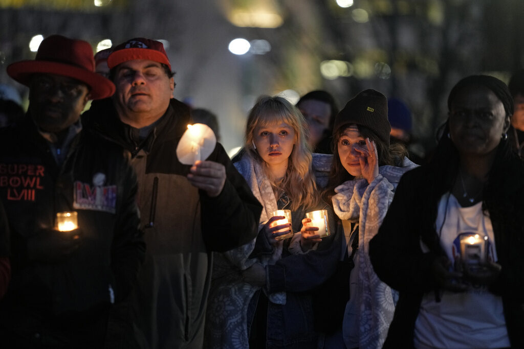Chiefs Parade Shooting Football People hold candles at a vigil