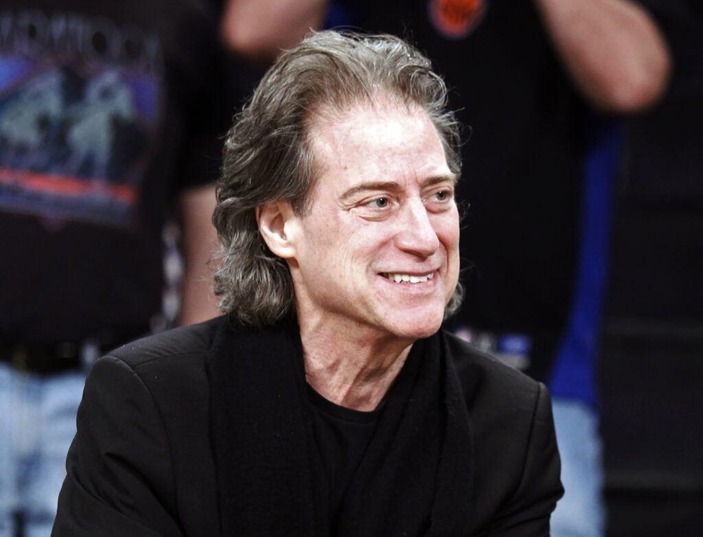 Richard Lewis File photo: Comedian Richard Lewis attends an NBA basketball game in Los Angeles on Dec. 25, 2012. Lewis, an acclaimed comedian known for exploring his neuroses in frantic, stream-of-consciousness diatribes while dressed in all-black, leading to his nickname ''The Prince of Pain,'' has died. He was 76. He died at his home in Los Angeles on Tuesday night after suffering a heart attack, according to his publicist Jeff Abraham.