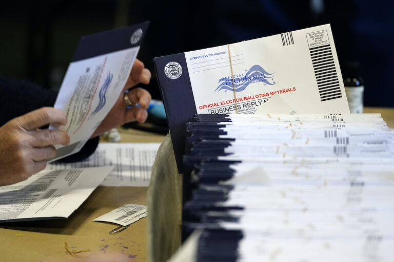 File photo: Chester County, Pa. election workers process mail-in and absentee ballots at West Chester University in West Chester on Nov. 4, 2020.
