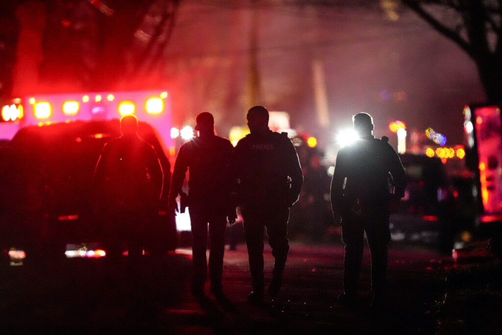 Police at the scene of the fire and shooting