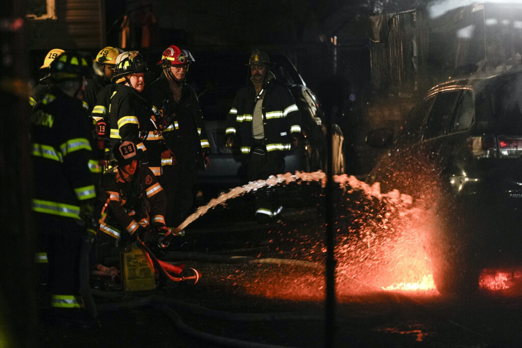 Police at the scene of the fire and shooting