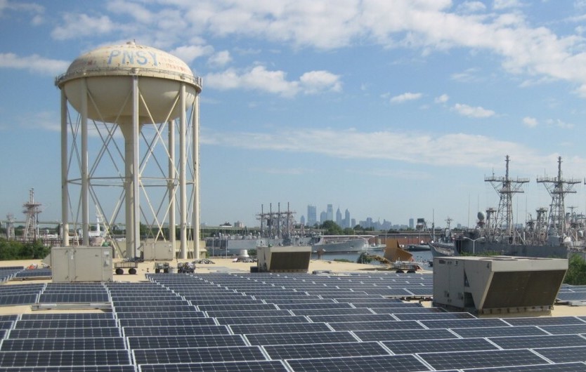 PNY-Comm-Solar-Project-Revzilla-Project-7-25-17-1024×542 A solar array on a rooftop at Philadelphia's Navy Yard is visible on a sunny day