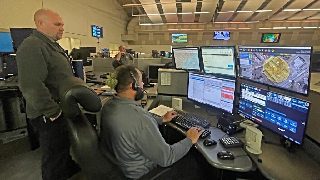 Photo Jan 23 2024, 11 11 41 AM (1) Supervisor Chris Williams observes dispatcher Onassis Burton taking a 911 call at the New Castle County emergency operations center south of Wilmington.