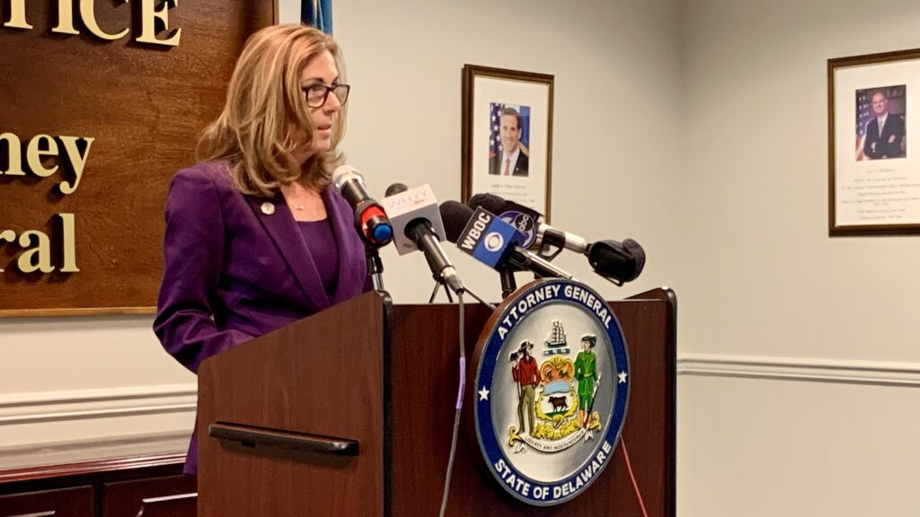 AG Kathy Jennings speaks at a podium