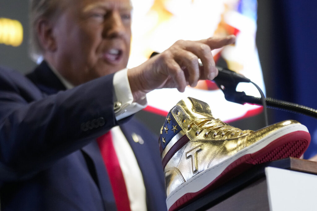 APTOPIX Election 2024 Trump Republican presidential candidate Donald Trump unveiled his golden high-tops at Sneaker Con Philadelphia, an event popular among sneaker collectors, on Saturday.