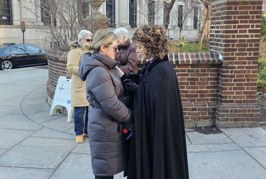 Rev. Sarah Hedgis-Kligerman giving someone ashes