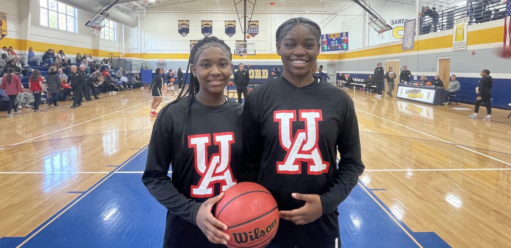 GG Banks and Taylor Brown posing on the basketball court