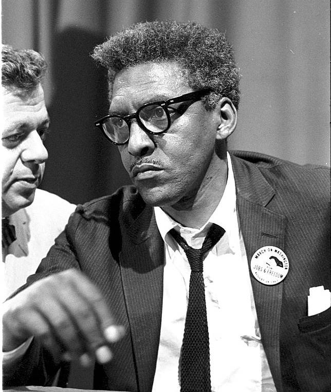 Bayard Rustin sitting at a table