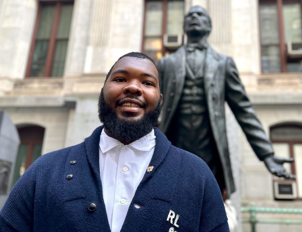 George Lane posing for a photo in front of the Octavius Catto statue