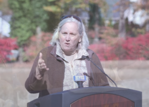 Dee Durham speaking at a podium