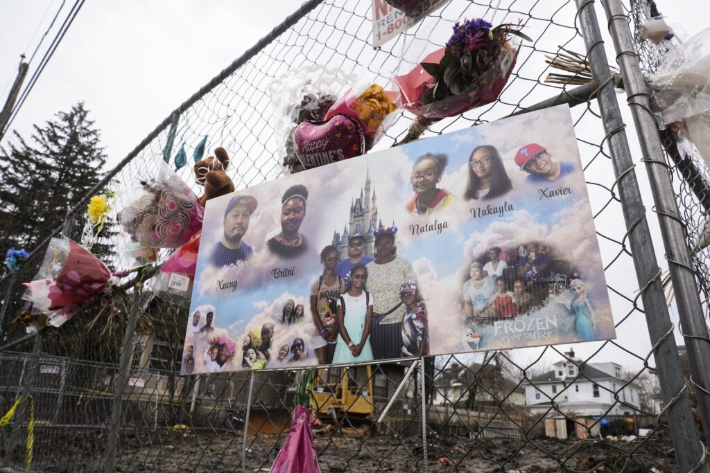 Officers-Wounded-House-Fire A makeshift memorial at the scene of a shooting and house fire that killed six members of an extended family in East Lansdowne, Pa., Wednesday, Feb. 28, 2024.