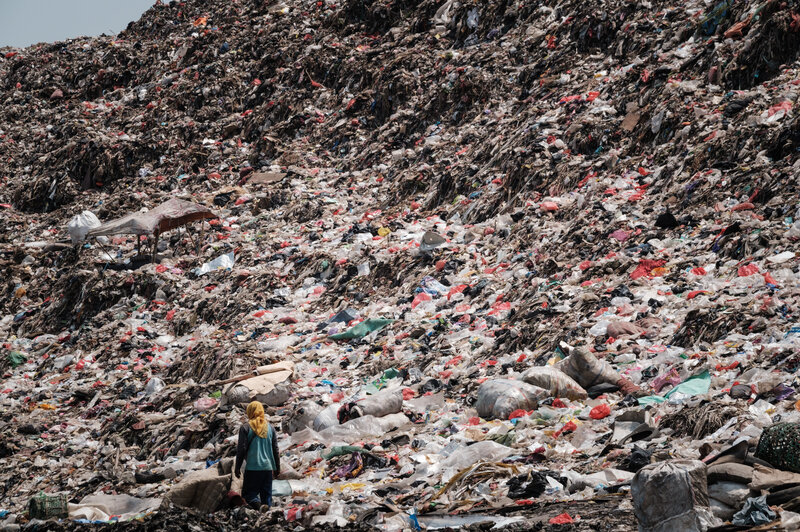 TOPSHOT-INDONESIA-ENVIRONMENT-WASTE A registered scavenger walks in a landfill in Indonesia.