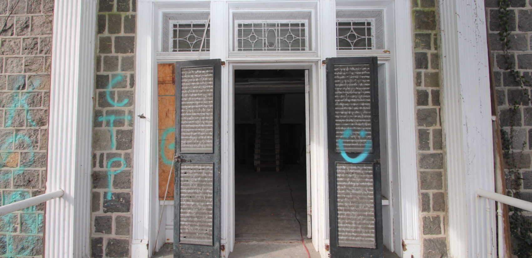 Graffiti on the outside of the mansion