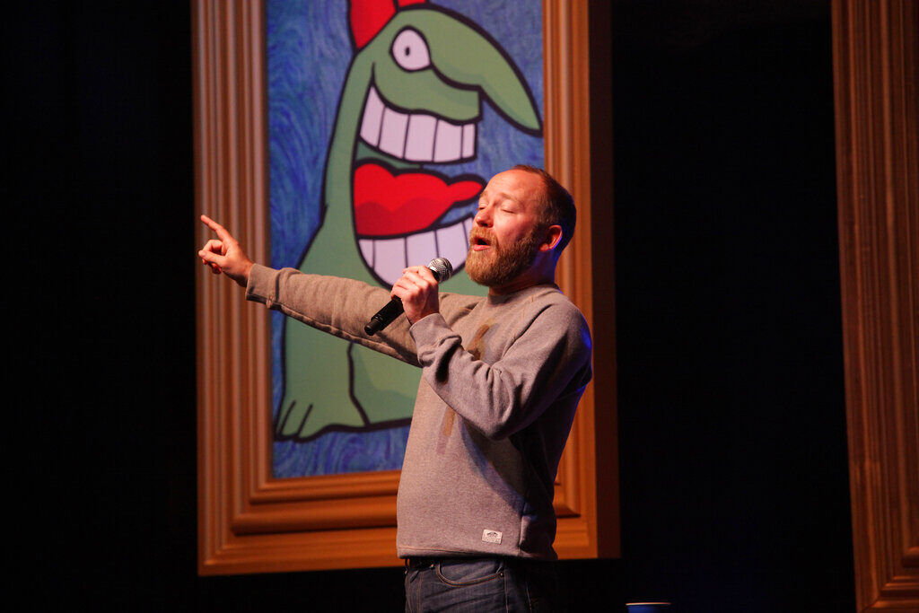 Kyle Kinane performing onstage