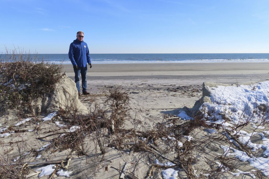 Defiant Shore Town Mayor Patrick Rosenello stands next to a destroyed section of sand dune in North Wildwood