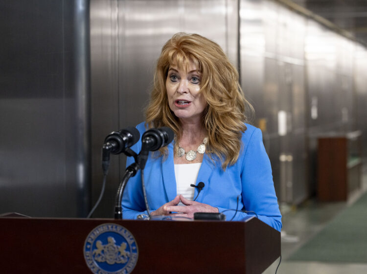 Stacy Garrity speaking at a podium