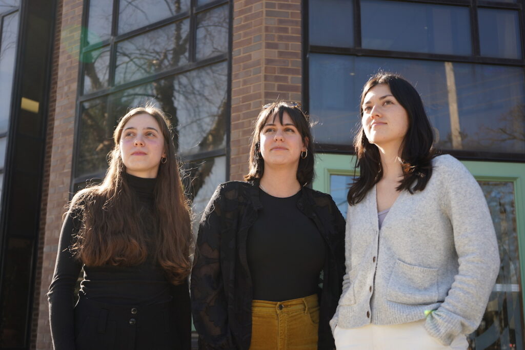 pfj-delco-6 Evie Gentile, Sophie Cloarec and Christina Higashi-Howard pose for a photo together outside of a building