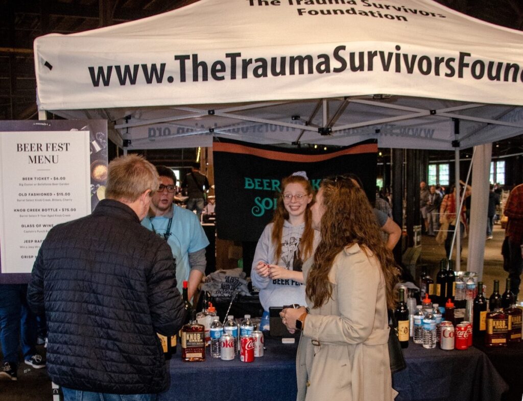 People standing together at a table at the Philly Beer Fest
