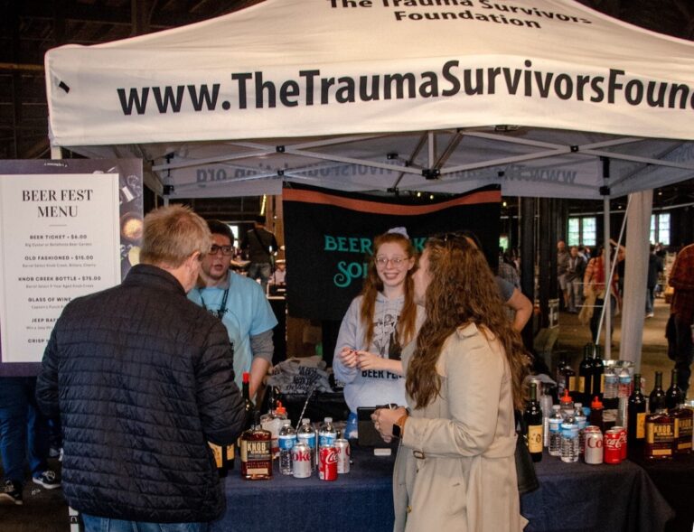 People standing together at a table at the Philly Beer Fest