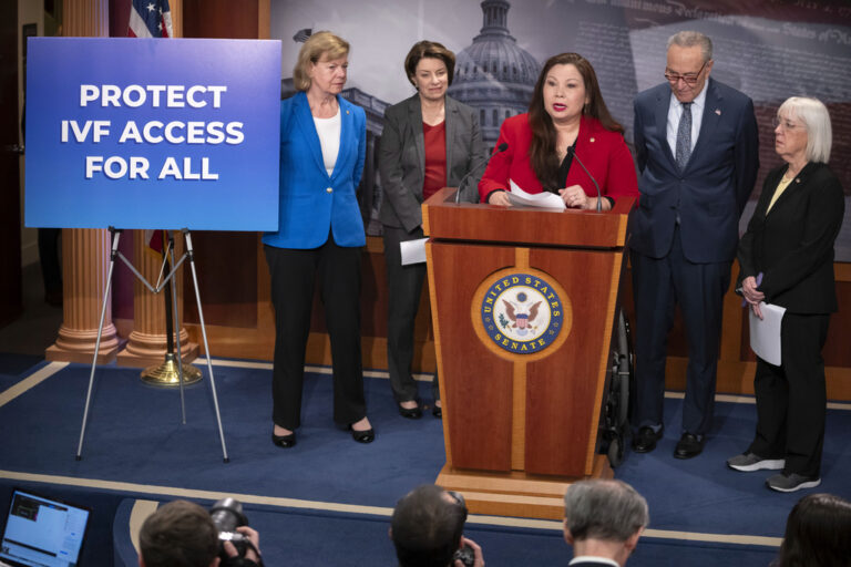 Sen. Tammy Duckworth, D-Ill., center, speaks about a bill to establish federal protections for IVF