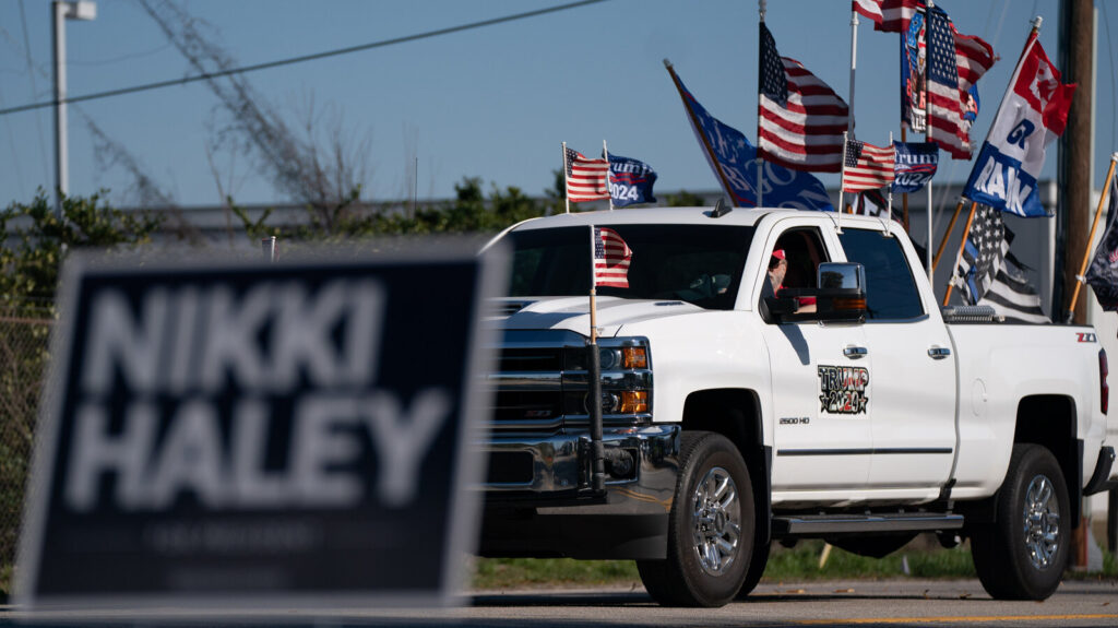 Nikki Haley Presidential Campaign in South Carolina A sign reads Nikki Haley. In the background is a truck with the U.S. flag and flags supporting Trump