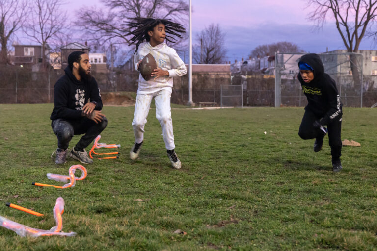 Kids play on a football field
