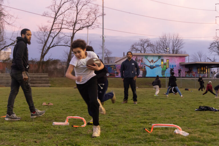 Kids play football on a field