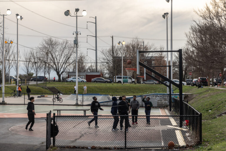 Kids play on a basketball court