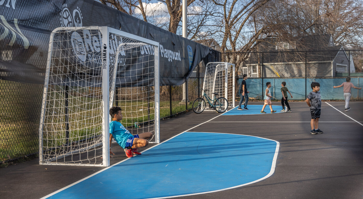 Kids play soccer on a field