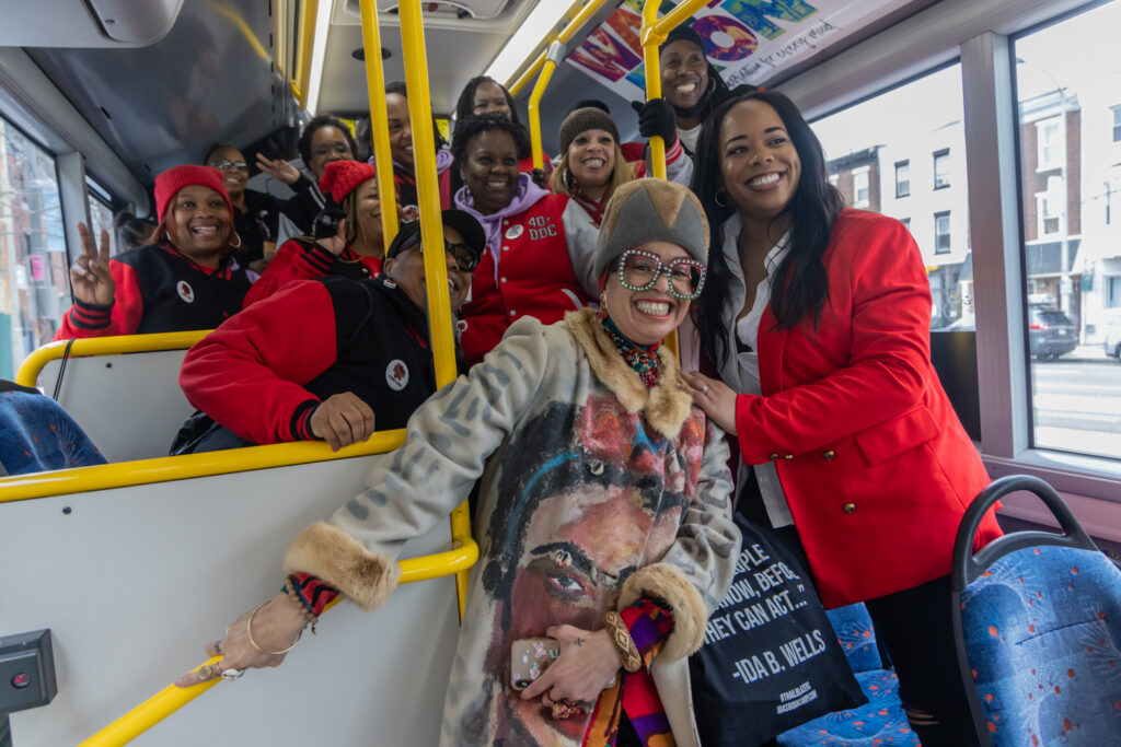 03 09 2024 k paynter reduced size sisterhood sit-in trolley tour The Sisterhood Sit-In Trolley Tour’s guide, Starfire, poses with Philadelphia’s 40+ double dutch team on the bus on March 9, 2024.