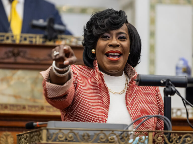 Cherelle Parker at a podium smiling and pointing to the audience